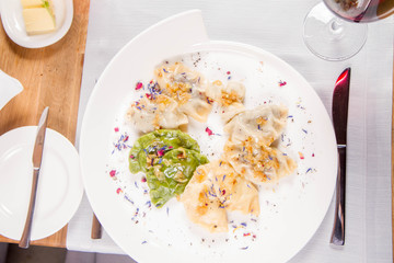 Dumplings with different kinds of stuffing decorated on a plate served in a restaurant