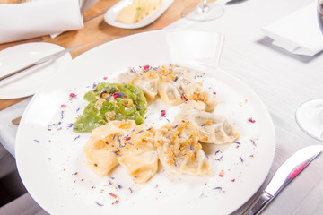 Dumplings with different kinds of stuffing decorated on a plate served in a restaurant