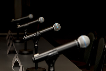 Microphones in press conference room, prepared for press conference.