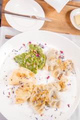 Dumplings with different kinds of stuffing decorated on a plate served in a restaurant