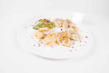 Dumplings with different kinds of stuffing decorated on a plate