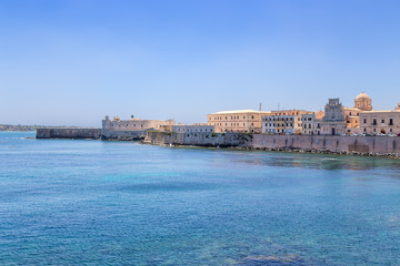 Syracuse, Italy. The landscape of the promenade of the island of Ortygia: Maniace Castle (1232-1240) and the church in the name of the Holy Spirit, 1727 - 1797