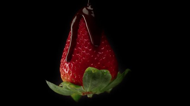 strawbery covered by black chocolate. Slow motion from 60fps