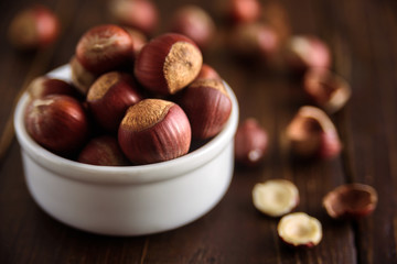 Hazelnuts in white ceramic bowl