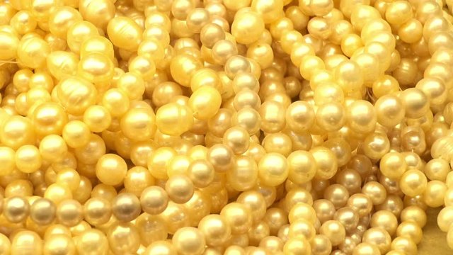 Heaps of pearl necklaces in the shop window of a jewelry store. HD video clip     