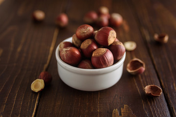 Hazelnuts in white ceramic bowl