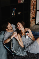 Young stylish hipsters couple. guy and girl in love hugging together. Indoors. Portrait. interior in style the loft. lifestyle moments at home 