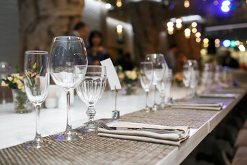 Wedding. Banquet. The chairs and table for guests, served with cutlery and crockery.