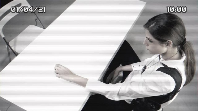 Female fbi agent waiting in interrogation room from surveillance camera