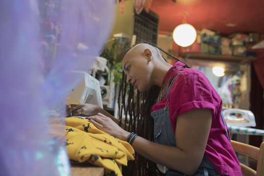 Side view of young female designer working at studio