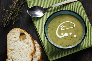 Green soup on a dark wooden table
