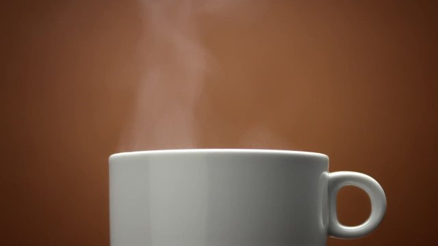 closeup of white cup with hot drink. Steam from cup closeup. Hot coffe. loop