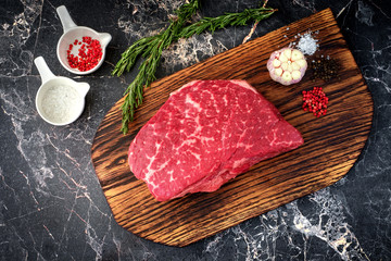 fresh meat with ingredients for cooking on stone background