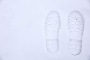 Footprints of shoes on fresh snow.