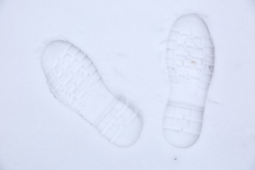 Footprints of shoes on fresh snow.