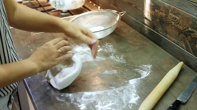 Woman's hands knead sugar mastic for making dessert