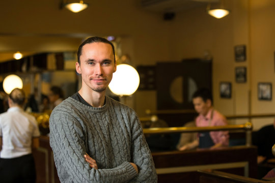 Smiling casual man in cafeteria