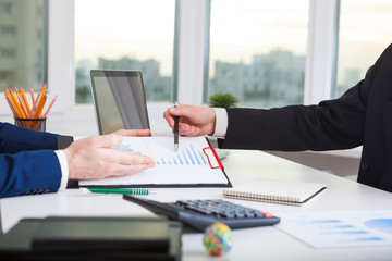 Team work process. Marketing strategy brainstorming. Paperwork and digital in office.