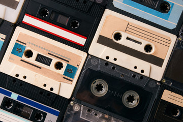 Retro cassette tapes collection background, close-up. Colorful vintage audio cassette, view from...