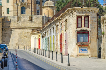 Fototapeta premium A typical narrow street with colorfull doors in Valletta