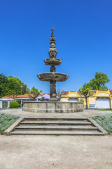 Fototapeta na wymiar Fountain of Campo das Hortas (Chafariz do Campo das Hortas, 1594) - fountain located in the centre of garden space fronting the Arco da Porta Nova in Braga. Portugal.