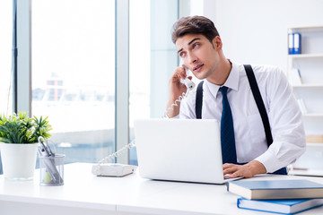 Young stylish businessman working in the office