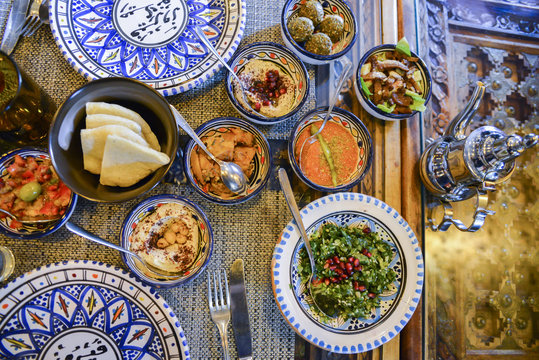 Middle eastern or arabic dishes and assorted meze, concrete rustic background