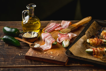 Cooking spicy peppers with cheese and meat bacon. Food recipe on wooden background.