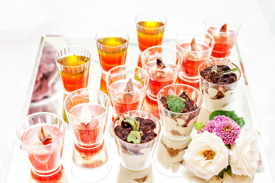 Fruit and chocolate desserts on a glass rack. Concept party, wedding, restaurant, catering, dessert.