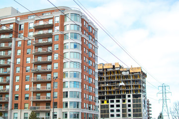 Construction and modern condo buildings with huge windows and balconies in Montreal, Canada.