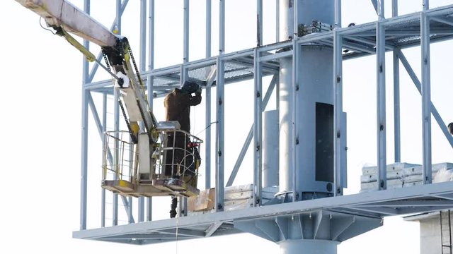 Steel structure for an advertising banner on the wall. construction site and blank billboard and blue sky
