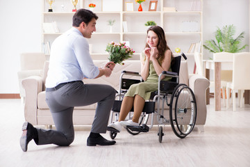 Man making marriage proposal to disabled woman on wheelchair