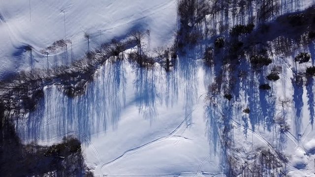 Aerial top down view on snowy highway e18 and houses covered with snow in Drammen city, Norway