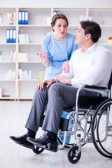 Fototapeta na wymiar Disabled patient on wheelchair visiting doctor for regular check