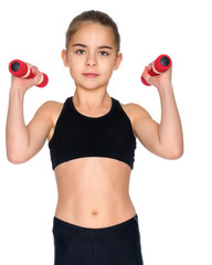 Little girl doing exercises with dumbbells.