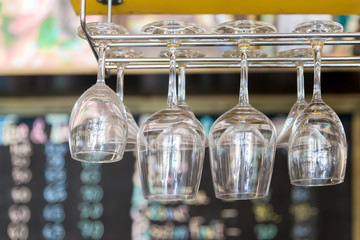 Empty glasses on a bar rack in restaurant