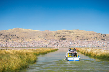 Fototapeta na wymiar A boat is heading to the Puno Port - Peru