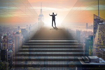 Businessman climbing up challenging career ladder in business co