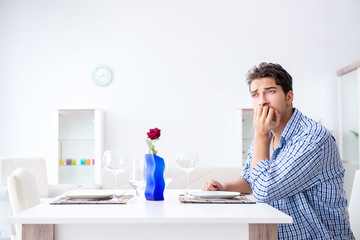 Man alone preparing for romantic date with his sweetheart