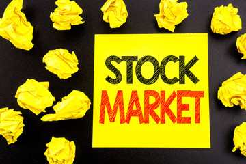 Conceptual hand writing text showing Stock Market. Business concept for Equity Share Exchange written on sticky note paper. Folded yellow papers on the background