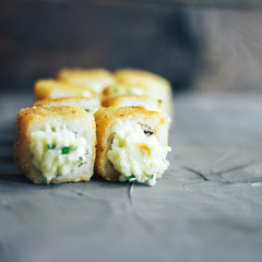 Japanese sushi roll, hot and fried, tempura maki on concrete grey background