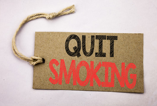 Hand writing text caption inspiration showing Quit Smoking. Business concept for Stop for Cigarette  written on price tag paper on the white vintage background.