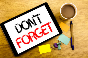 Handwritten text caption showing Do Not Forget. Business concept writing for Don t memory Remider Written on tablet laptop, wooden background with sticky note, coffee and pen