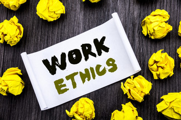 Fototapeta premium Writing text showing Work Ethics. Business concept for Moral Benefit Principles Written on sticky note notepad note notebook book wooden background with yellow sticky folded.