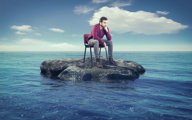 Young man thoughtfully on a chair