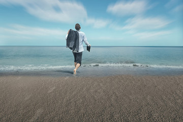 Businessman with feet in water