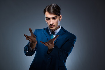 Businessman pressing virtual buttons on gray background