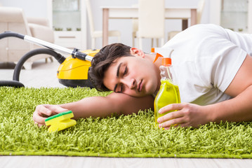 Young husband man cleaning floor at home