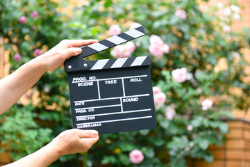 Hand with a clapperboard