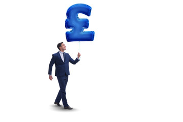 Businessman holding british pound sign inflatable balloon